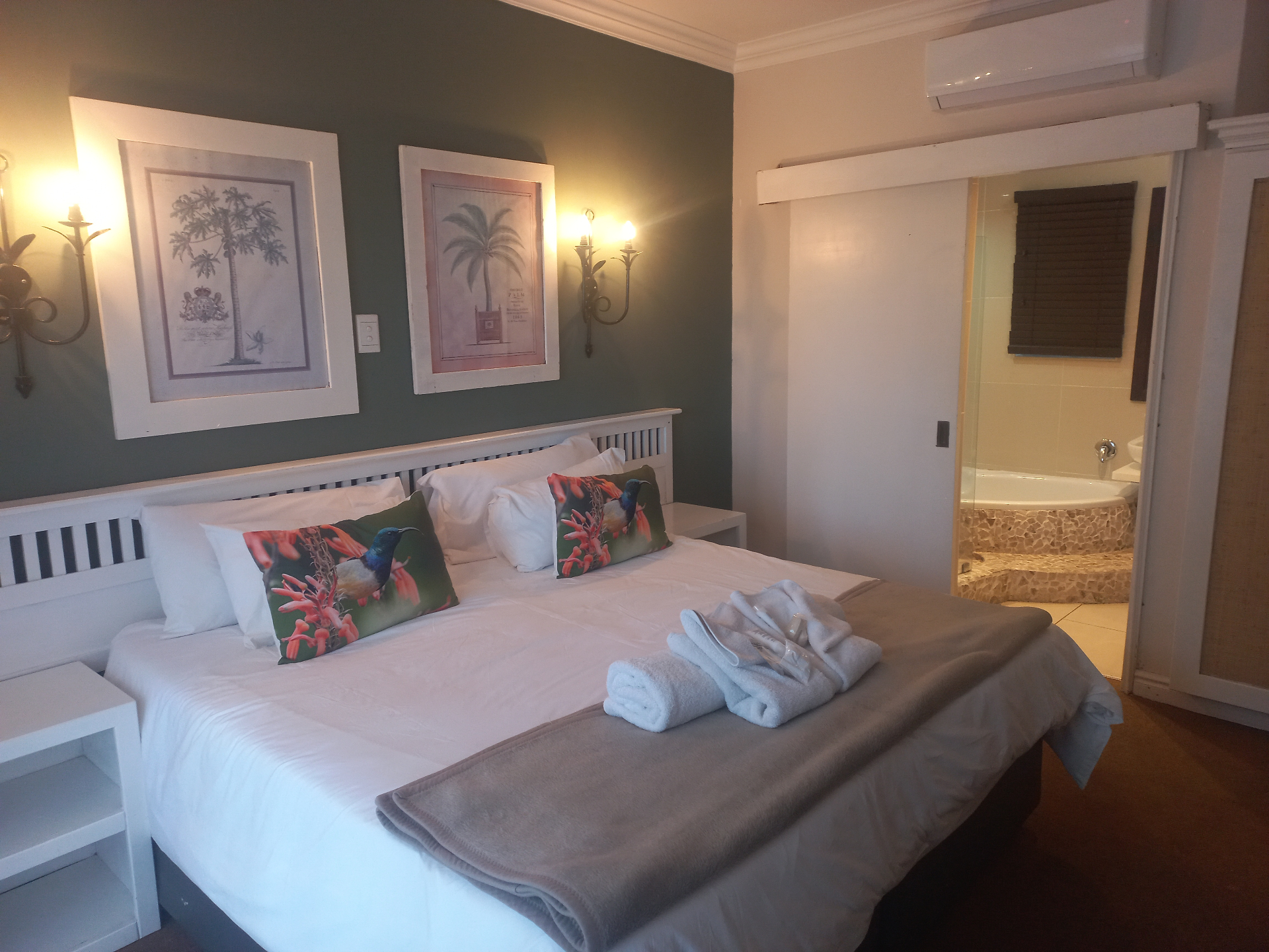 Raphia room with feature wall art and bed styling.